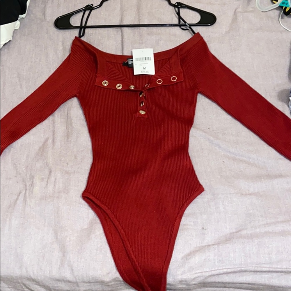 Long sleeve burgundy knit body suit.